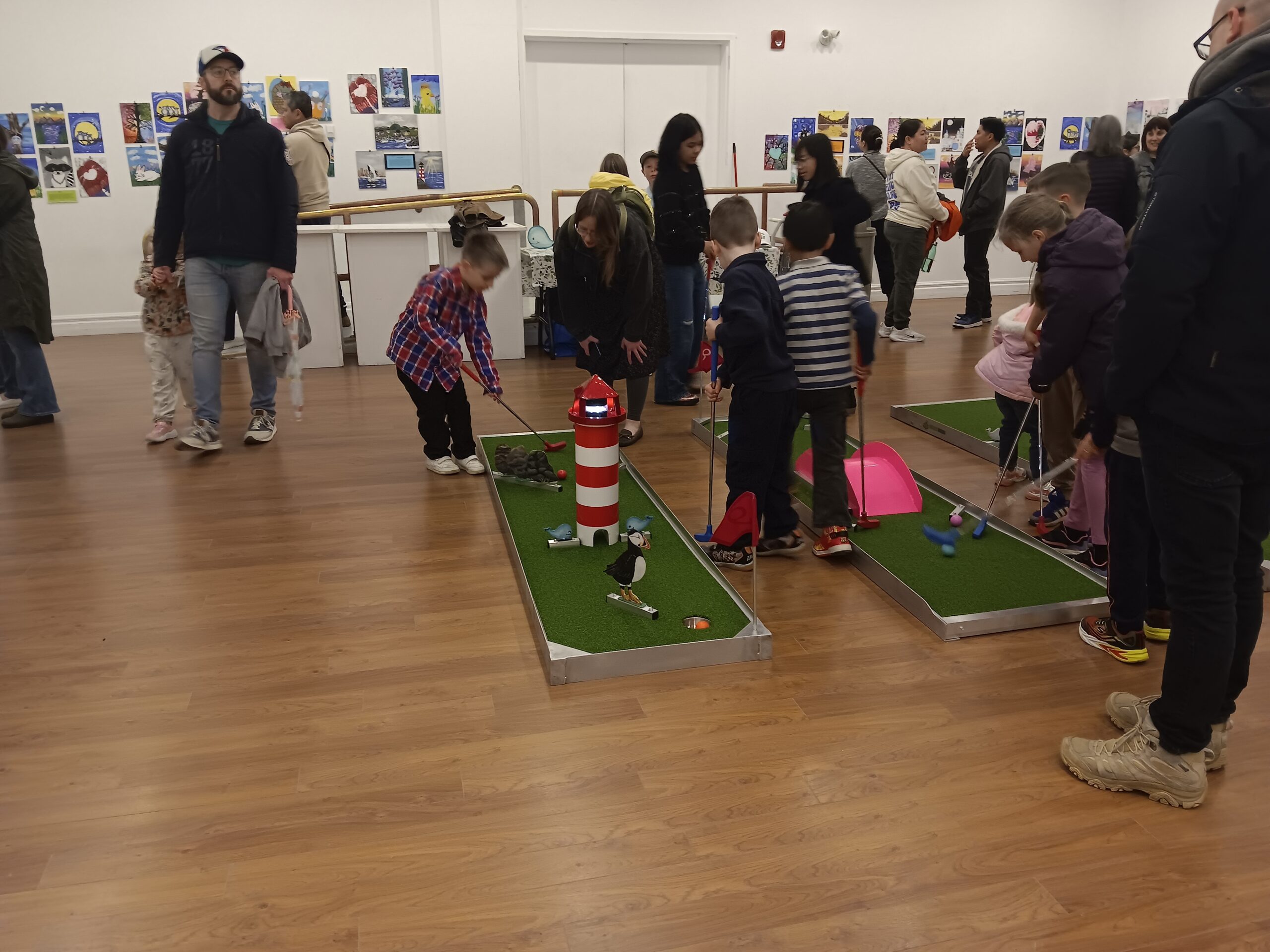 Just Puttin' and Paintastic Art Exhibit 01 Students and parents at the Gander Arts and Culture Centre for their amazing painting skills!! Just Puttin' obstacles were painted by the kids as they learned more about Newfoundland & Labrador. The Paintastic Art Exhibit was led by the amazing Sandy Moss. Just Puttin' put forth donations towards the Gander SPCA.